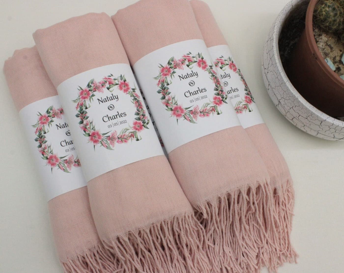 Pale pink pashmina shawl favours wrapped with floral name bands